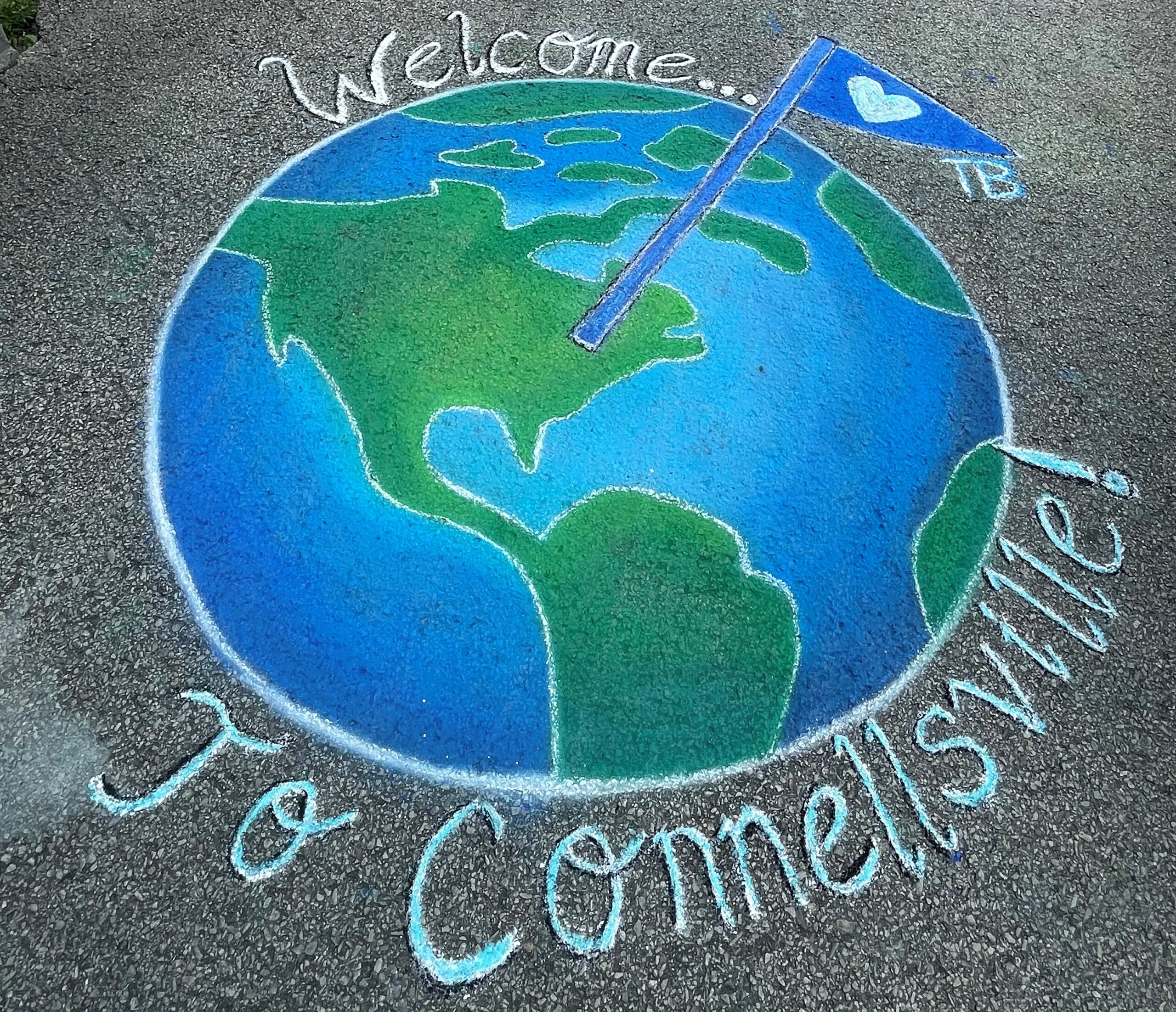 chalk drawing of the earth on pavement that says welome to Connellsville