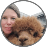 Katie Maitland headshot, with alpaca sharing the frame